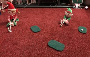 Elves playing golf with candy canes and mint imperials