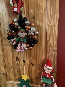 Elf on the shelf ideas: sit in the wreath