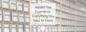 Shelves filled with neatly arranged metal tea canisters, each labelled with different tea varieties. Overlay text in the centre reads: Hebden Tea Experience: Everything You Need to Know.